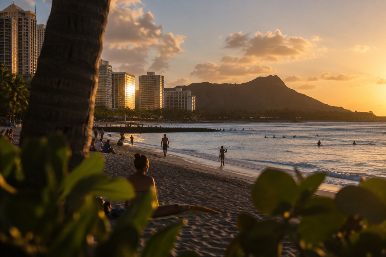 Waikīkī beach at golden hour with the Koʻolau mountains behind the hotels