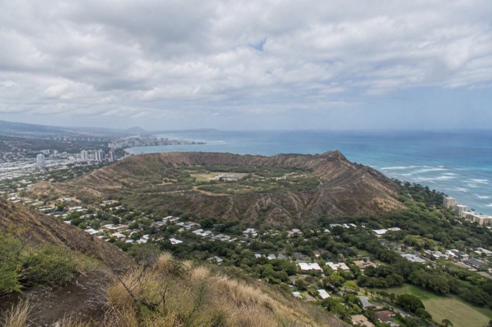 The Diamond Head crater seen from the air above the Honolulu coastline on a clear morning