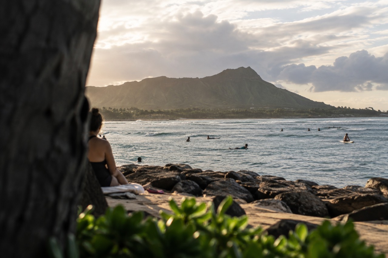 Warm evening light over the Waikiki coastline with the Koʻolau mountains in the background