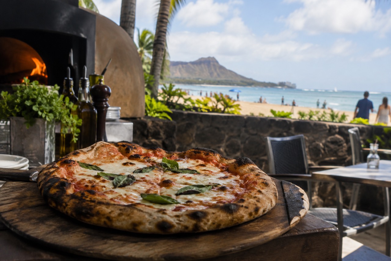 A wood-fired pizza fresh out of an oven on an outdoor terrace in Hawaii