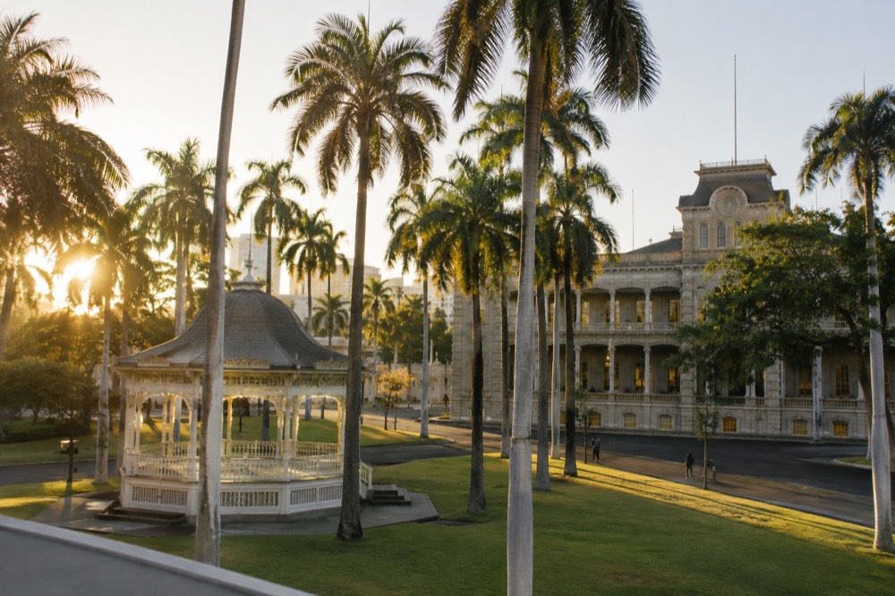 The palace grounds seen from the corner of the block, with the coronation pavilion and palm trees in the foreground