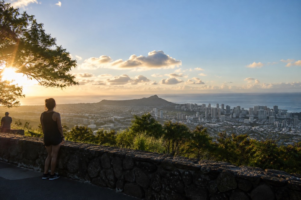 A stone-walled overlook above Honolulu with the city grid, ocean and Diamond Head visible below