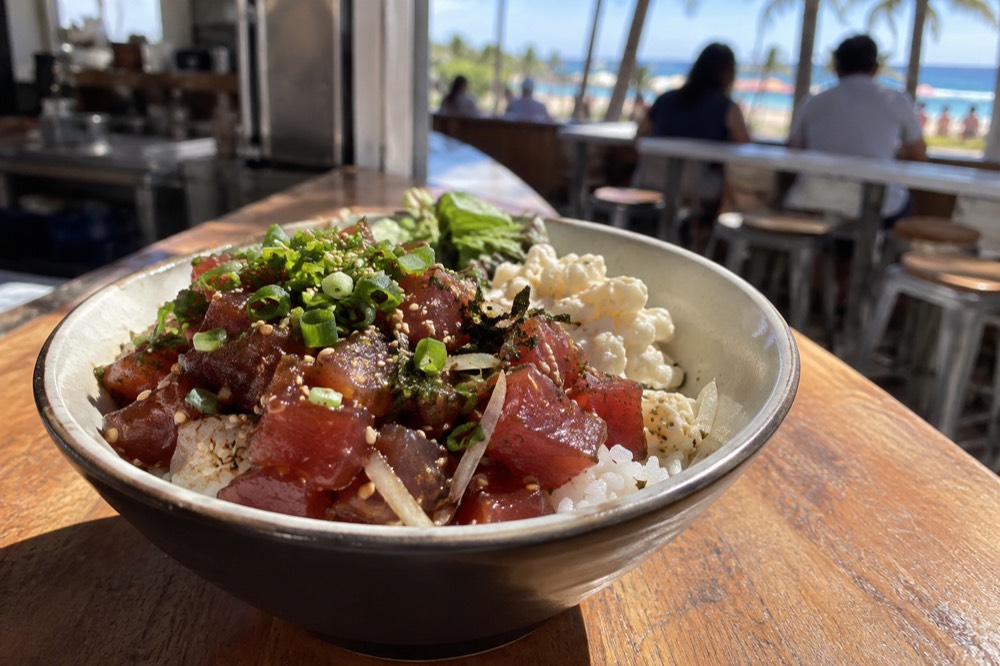 A bowl of fresh poke with rice served at a small counter restaurant in Honolulu