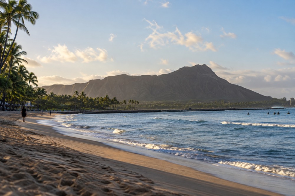 A quiet stretch of Waikiki Beach in the morning with Diamond Head in the distance