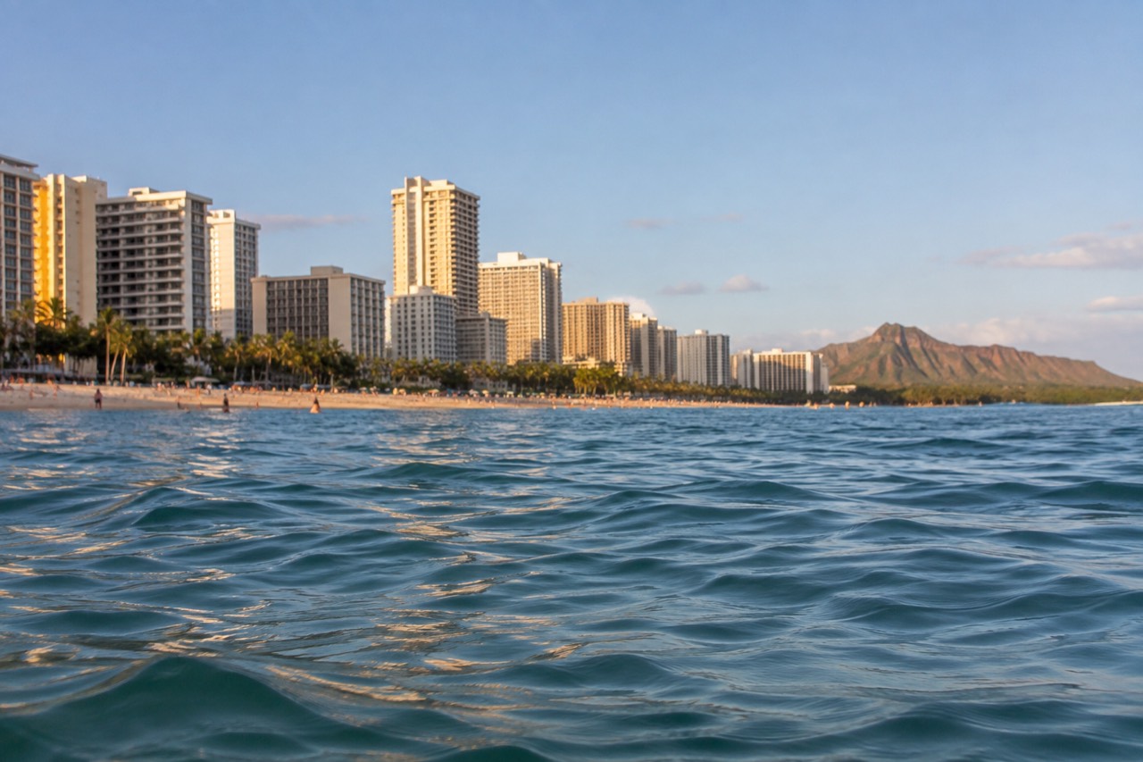 Waikiki Beach and the Honolulu skyline seen from the water on a clear afternoon