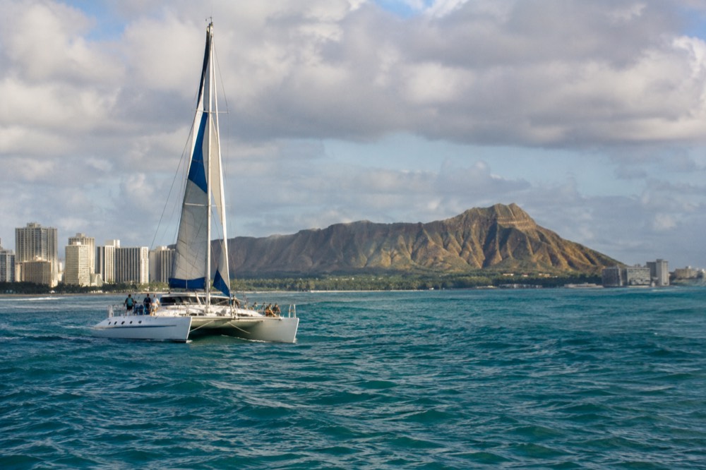A catamaran off Waikiki with the Diamond Head crater on the horizon