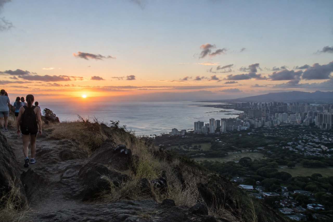 Diamond Head crater rising above Waikiki's coastline at sunrise