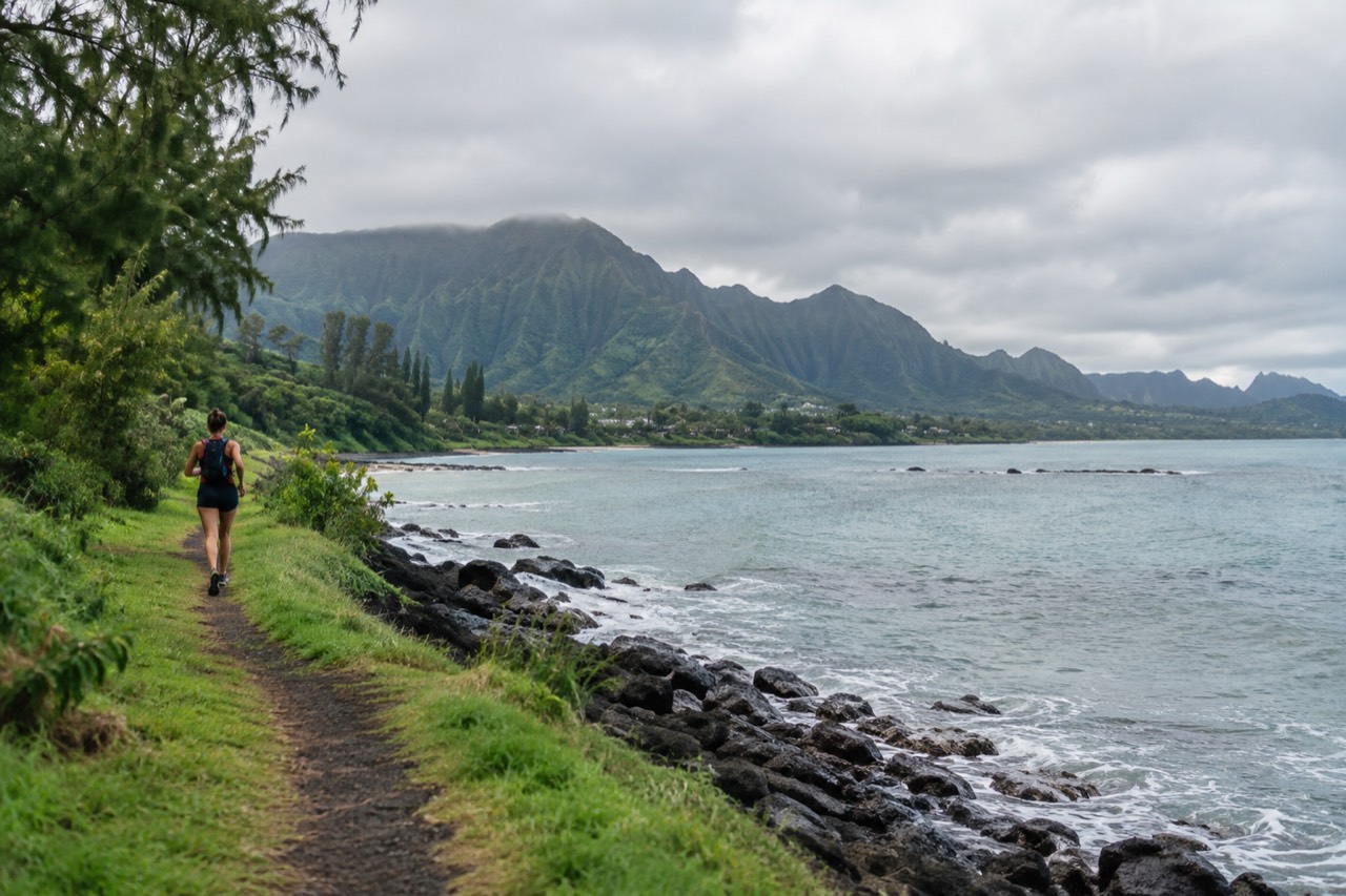 A view of Oahu's windward coast with green ridges meeting a calm blue bay